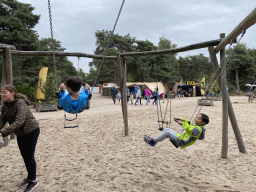 Max and his friend on a swing at the playground of the Afrikadorp village at the Safaripark Beekse Bergen