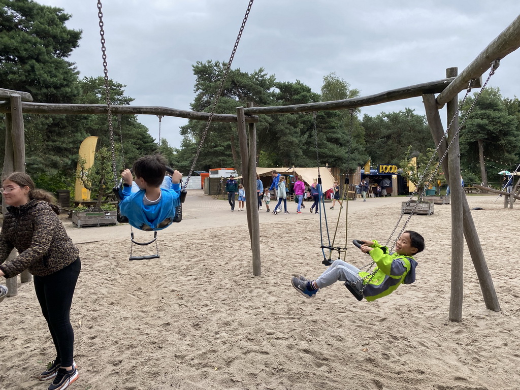 Max and his friend on a swing at the playground of the Afrikadorp village at the Safaripark Beekse Bergen