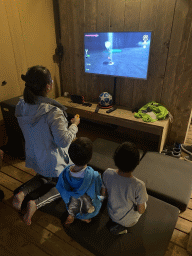 Miaomiao, Max and his friend playing `The Legend of Zelda: Skyward Sword` in the living room of our safari tent at the Safari Resort at the Safaripark Beekse Bergen