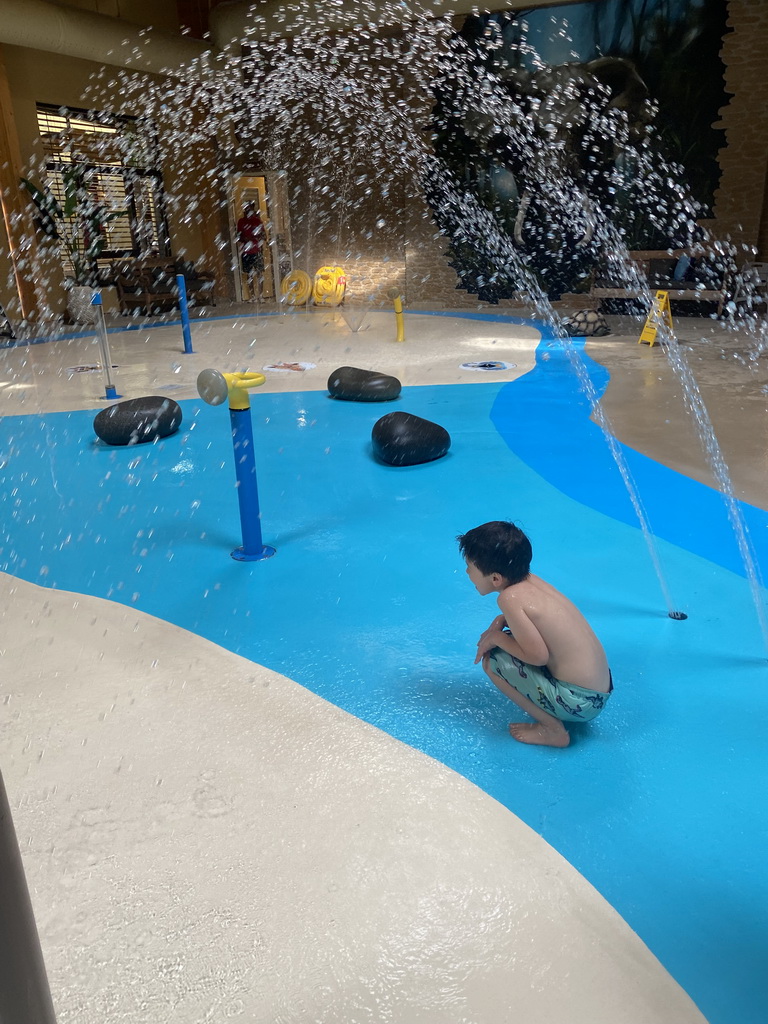 Max playing with water at the Maji Springs swimming pool at Karibu Town at the Safari Resort at the Safaripark Beekse Bergen