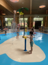 Max and his friend playing with water at the Maji Springs swimming pool at Karibu Town at the Safari Resort at the Safaripark Beekse Bergen