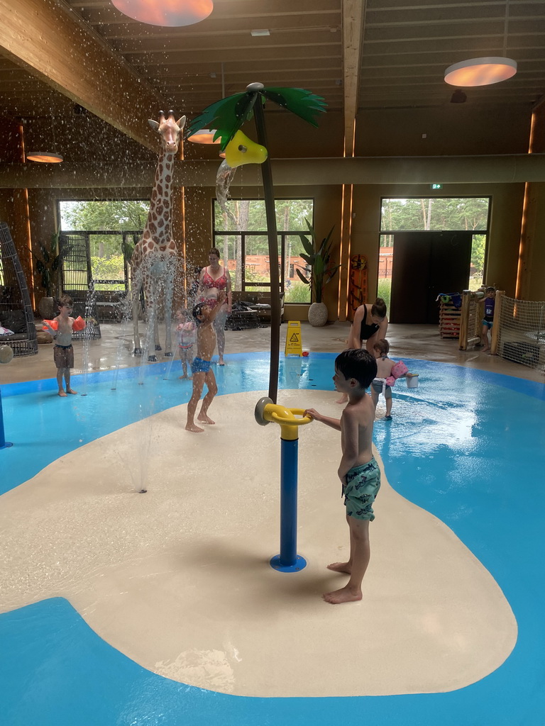 Max and his friend playing with water at the Maji Springs swimming pool at Karibu Town at the Safari Resort at the Safaripark Beekse Bergen