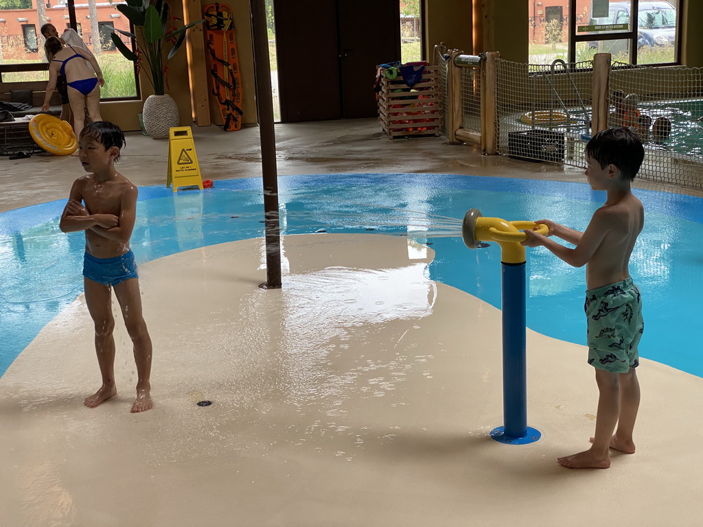 Max and his friend playing with water at the Maji Springs swimming pool at Karibu Town at the Safari Resort at the Safaripark Beekse Bergen