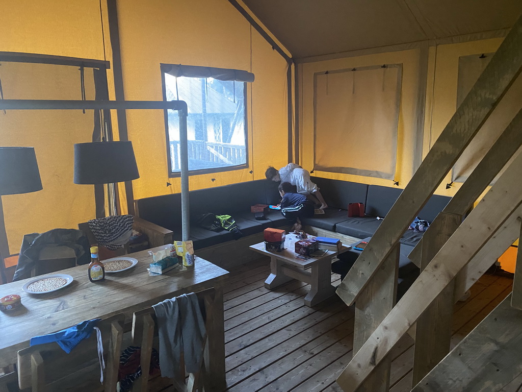 Max and his friend playing with iPad on the sofa in the living room of our safari tent at the Safari Resort at the Safaripark Beekse Bergen