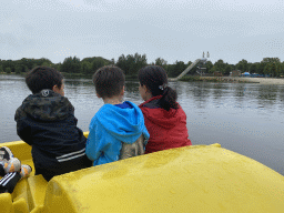 Max and our friends on a pedal boat at Speelland Beekse Bergen, with a view on the Aquashuttle attraction
