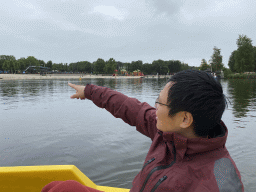 Our friend on a pedal boat at Speelland Beekse Bergen, with a view on the Duo Water Slide attraction and the Speelstraat playground