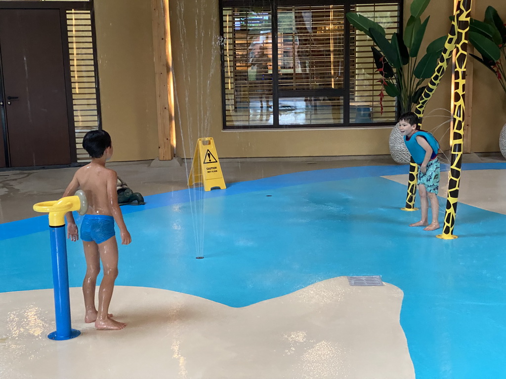 Max playing with water at the Maji Springs swimming pool at Karibu Town at the Safari Resort at the Safaripark Beekse Bergen