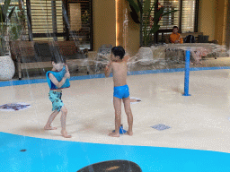 Max playing with water at the Maji Springs swimming pool at Karibu Town at the Safari Resort at the Safaripark Beekse Bergen