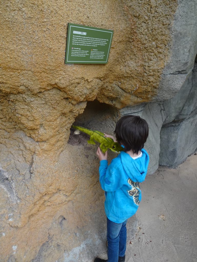 Max with his plush crocodile toy and a Crocodile egg statues at the Hippopotamus and Crocodile enclosure at the Safaripark Beekse Bergen