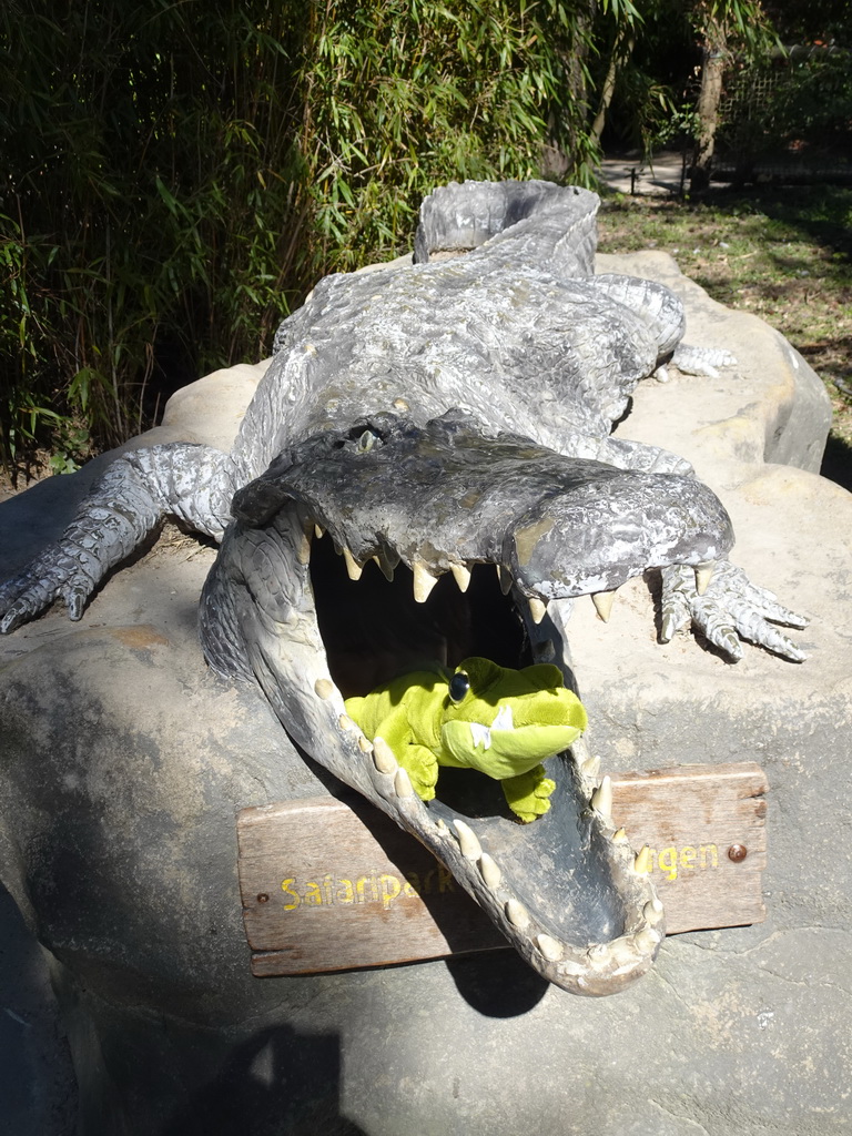 Max`s plush crocodile toy in a crocodile statue in front of the Hippopotamus and Crocodile enclosure at the Safaripark Beekse Bergen