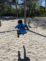 Max on a swing at the playground of the Afrikadorp village at the Safaripark Beekse Bergen