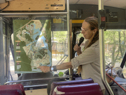 The tour guide with a map at the bus at the Safaripark Beekse Bergen, during the Bus Safari