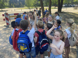 Max and his friend with the tour guide of the Bus Safari at the parking lot at the Kongoplein square at the Safaripark Beekse Bergen