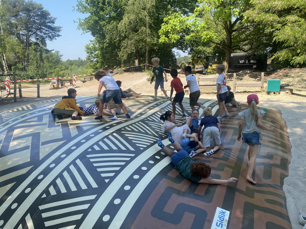 Max and his friends on the trampoline at the playground at the Kongoplein square at the Safaripark Beekse Bergen