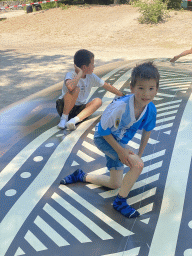 Max and his friend on the trampoline at the playground at the Kongoplein square at the Safaripark Beekse Bergen