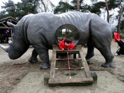 Max with a Rhinoceros statue at the playground of the Afrikadorp village at the Safaripark Beekse Bergen, during the Winterdroom period
