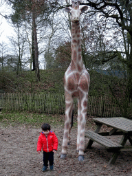 Max with a Giraffe statue at the playground of the Afrikadorp village at the Safaripark Beekse Bergen, during the Winterdroom period