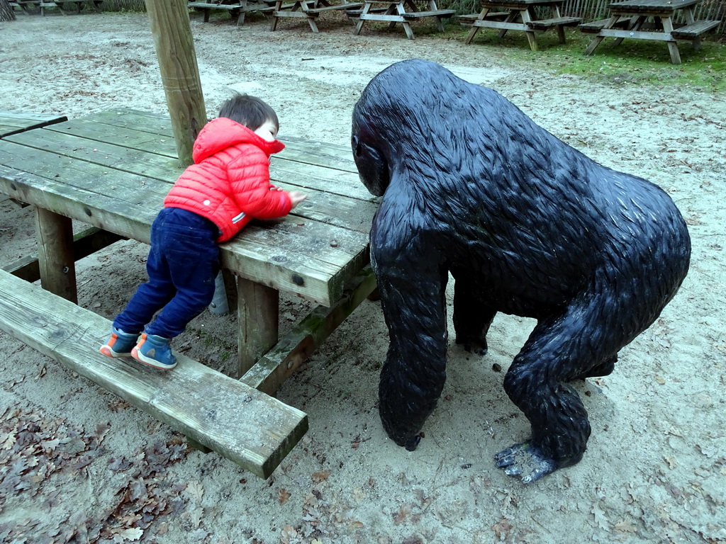 Max with a Gorilla statue at the playground of the Afrikadorp village at the Safaripark Beekse Bergen, during the Winterdroom period