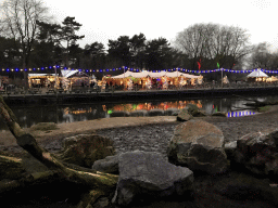 Tents with lights and decorations at the Kongoplein square at the Safaripark Beekse Bergen, during the Winterdroom period, at sunset