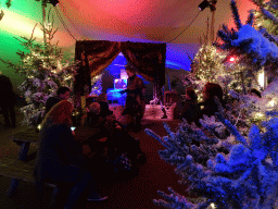 Story teller at the Verhalenverteller attraction at the Kongoplein square at the Safaripark Beekse Bergen, during the Winterdroom period, at sunset