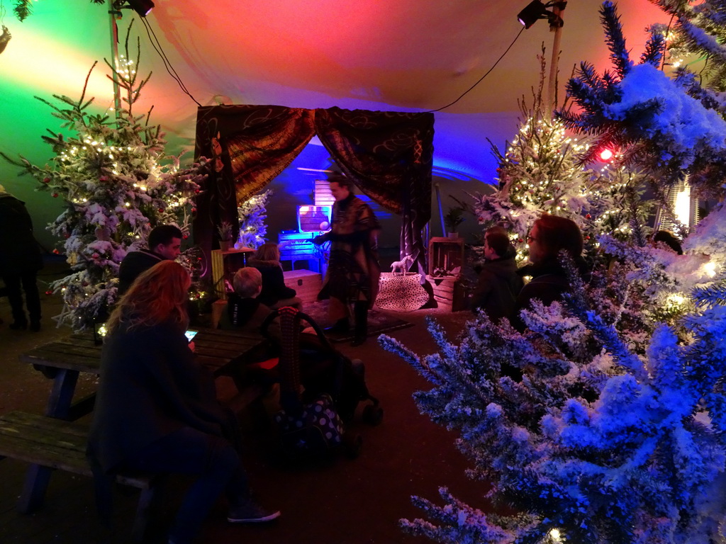 Story teller at the Verhalenverteller attraction at the Kongoplein square at the Safaripark Beekse Bergen, during the Winterdroom period, at sunset