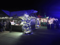 Tents with lights and decorations at the Kongoplein square at the Safaripark Beekse Bergen, during the Winterdroom period, by night
