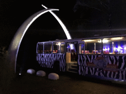 Gate and Safari Bus at the Safaripark Beekse Bergen, during the Winterdroom period, by night