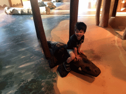 Max on a crocodile statue at the Ranger Basecamp at the Safari Resort at the Safaripark Beekse Bergen