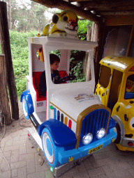 Max in a toy car in front of the Giraf shop at the Safaripark Beekse Bergen