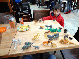 Max having lunch and playing with animal toys at the Kongo restaurant at the Safaripark Beekse Bergen