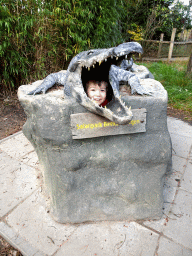 Max in a crocodile statue in front of the Hippopotamus and Crocodile enclosure at the Safaripark Beekse Bergen