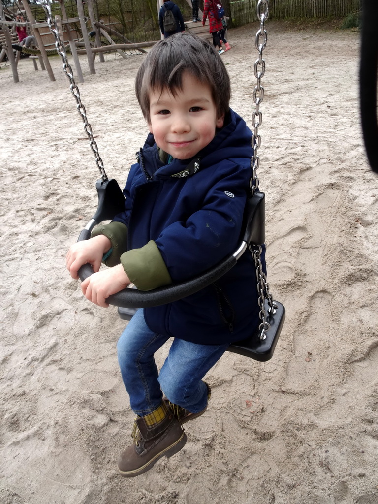 Max on the swing at the playground at the Afrikadorp village at the Safaripark Beekse Bergen