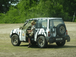 Zookeeper in a jeep at the Safaripark Beekse Bergen, viewed from the car during the Autosafari