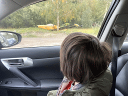 Max in the car during the Autosafari at the Safaripark Beekse Bergen, with a view on an airplane