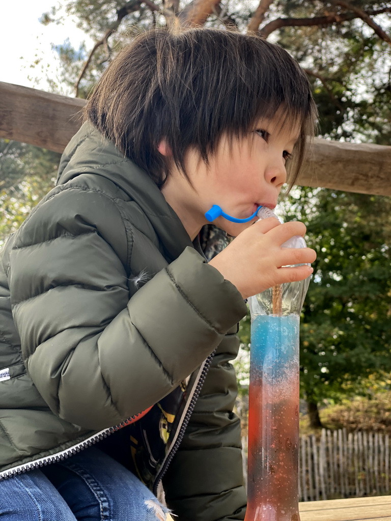 Max drinking a slush puppie at the playground of the Afrikadorp village at the Safaripark Beekse Bergen
