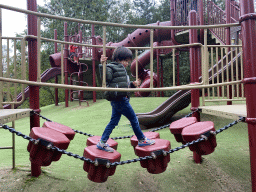 Max on a rope bridge at the playground at the Safariplein square at the Safaripark Beekse Bergen