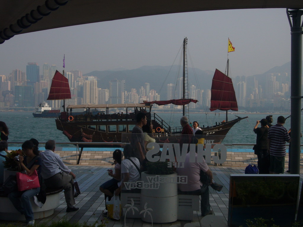 Boat in Victoria Harbour and the skyline of Hong Kong, viewed from a terrace of a restaurant at the Avenue of Stars