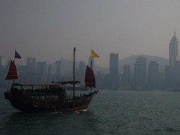 Boat in Victoria Harbour and the skyline of Hong Kong with the Central Plaza building, viewed from the Avenue of Stars