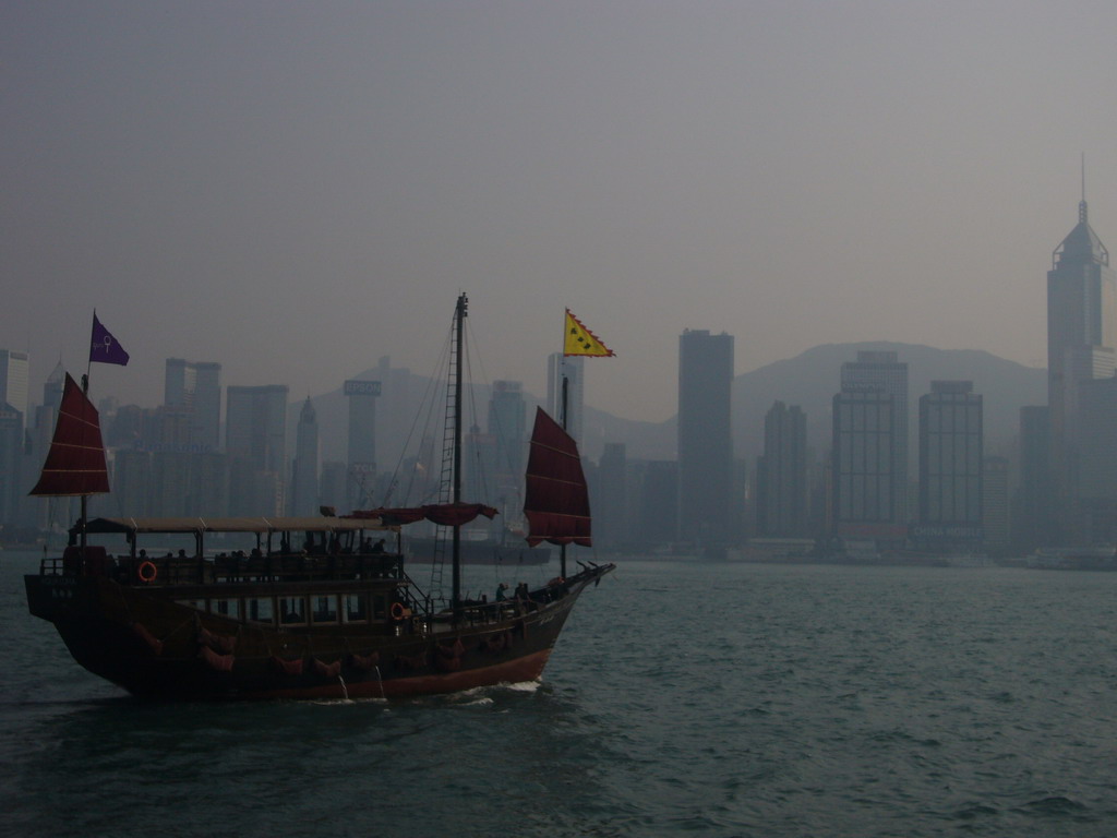 Boat in Victoria Harbour and the skyline of Hong Kong with the Central Plaza building, viewed from the Avenue of Stars