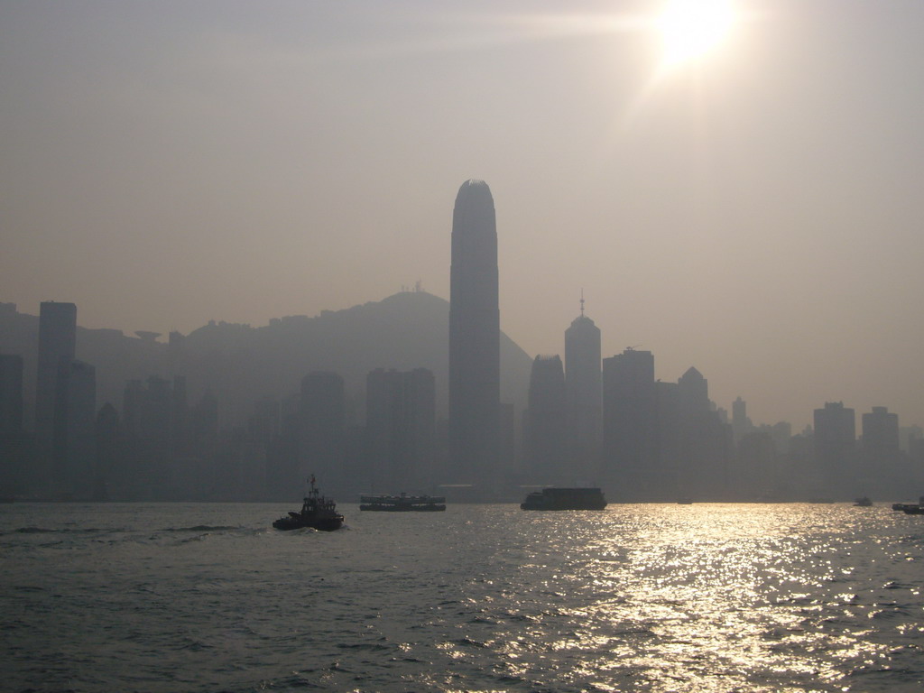 Boats in Victoria Harbour and the skyline of Hong Kong with the Two International Finance Centre and Victoria Peak, viewed from the Avenue of Stars