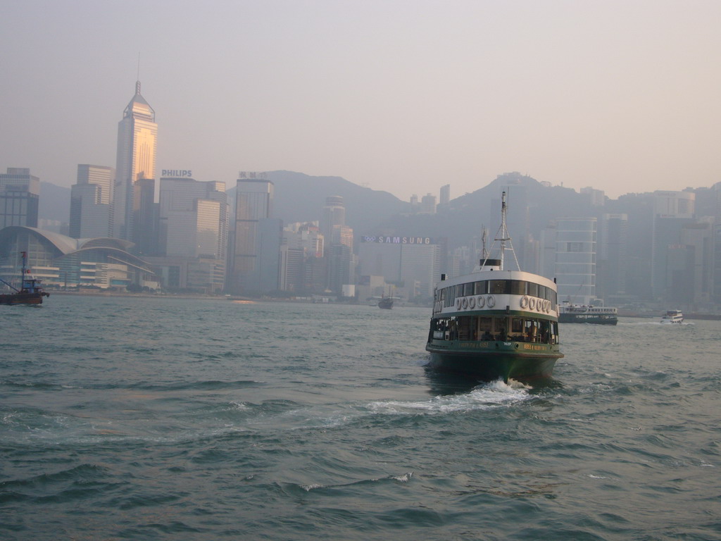 Boat in Victoria Harbour and the skyline of Hong Kong with the Central Plaza building and the Hong Kong Convention and Exhibition Centre, viewed from the Star Ferry from Kowloon to Hong Kong Island