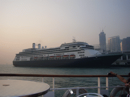 Cruise ship `Amsterdam` in Victoria Harbour and the skyline of Hong Kong, viewed from the Star Ferry from Kowloon to Hong Kong Island