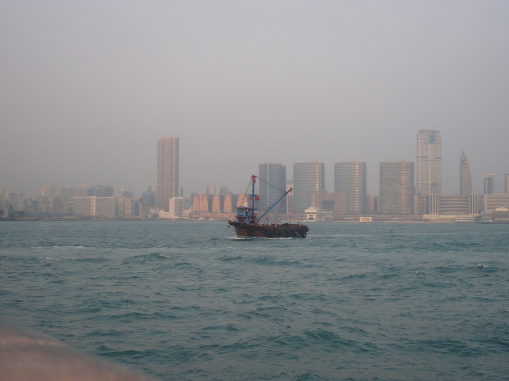 Boat in Victoria Harbour and the skyline of Kowloon, viewed from the Star Ferry from Kowloon to Hong Kong Island