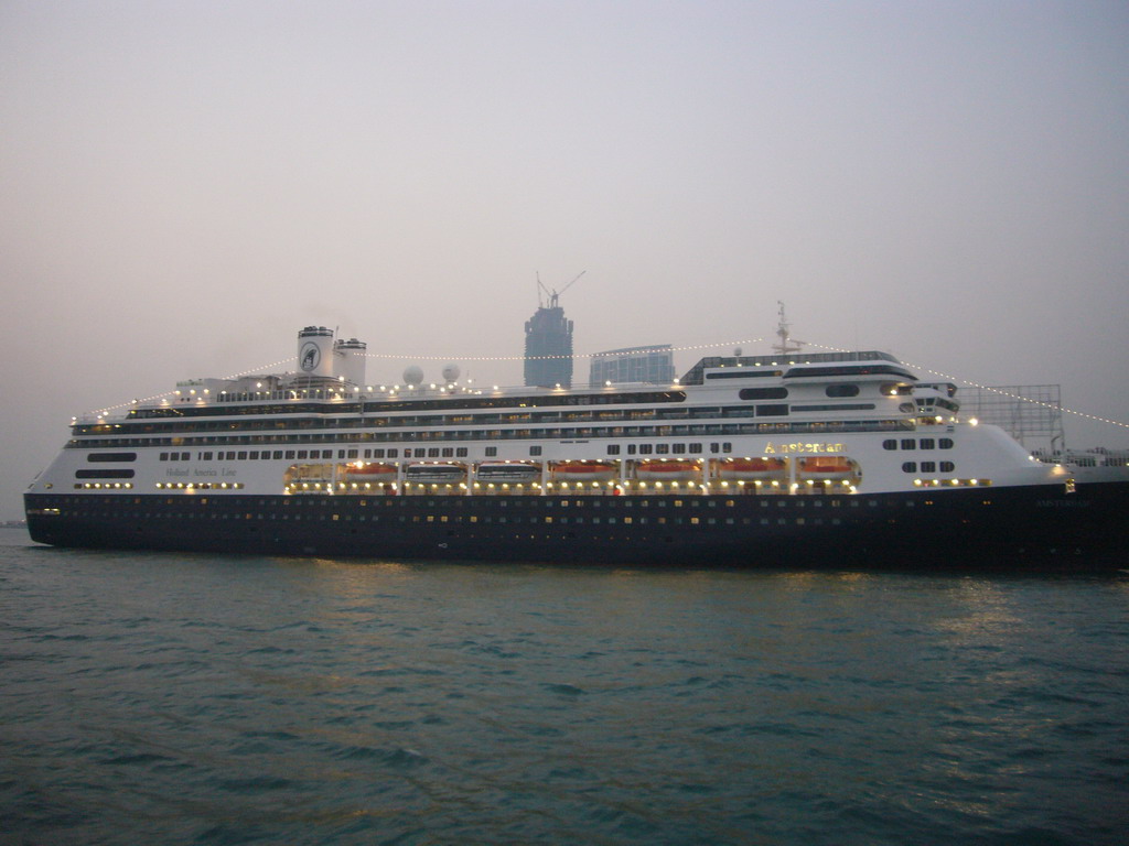 Cruise ship in Victoria Harbour and the skyline of Hong Kong with the International Commerce Centre, under construction, viewed from the Star Ferry from Hong Kong Island to Kowloon, at sunset