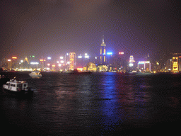 Boats in Victoria Harbour and the skyline of Hong Kong with the Hong Kong Convention and Exhibition Centre and the Central Plaza building, viewed from the Avenue of Stars, during the `A Symphony of Lights` light and sound show, by night