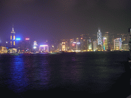 Boats in Victoria Harbour and the skyline of Hong Kong with the Hong Kong Convention and Exhibition Centre, the Central Plaza building and the Bank of China Tower, viewed from the Avenue of Stars, during the `A Symphony of Lights` light and sound show, by night