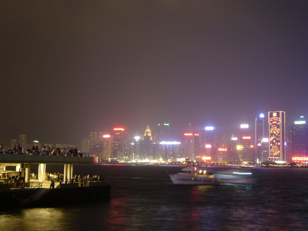 Boats in Victoria Harbour and the skyline of Hong Kong, viewed from the Avenue of Stars, during the `A Symphony of Lights` light and sound show, by night