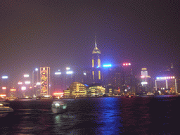 Boats in Victoria Harbour and the skyline of Hong Kong with the Hong Kong Convention and Exhibition Centre and the Central Plaza building, viewed from the Avenue of Stars, during the `A Symphony of Lights` light and sound show, by night