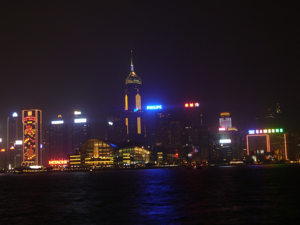 Victoria Harbour and the skyline of Hong Kong with the Hong Kong Convention and Exhibition Centre and the Central Plaza building, viewed from the Avenue of Stars, during the `A Symphony of Lights` light and sound show, by night