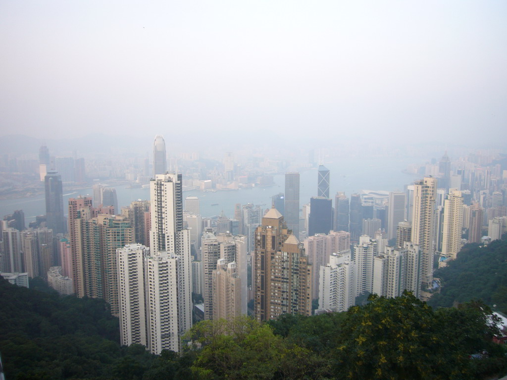 The skyline of Hong Kong and Kowloon with the International Commerce Centre, under construction, the Two International Finance Centre, the Bank of China Tower and the Central Plaza building, and Victoria Harbour, viewed from Victoria Peak, at sunset